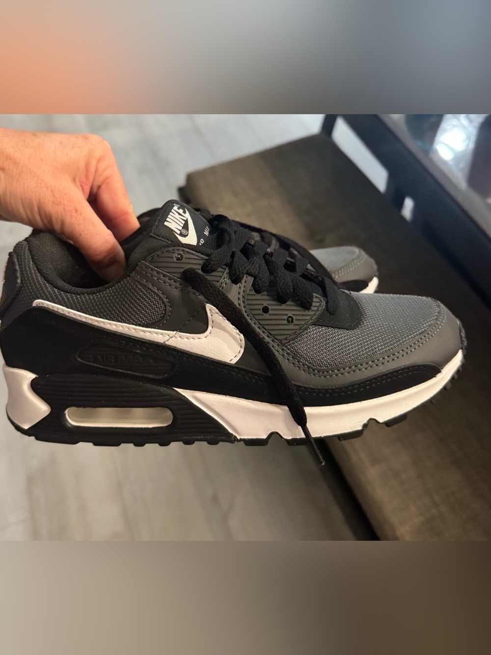 Nike Air Max 90 sneakers featuring a black, dark grey, and white colorway.
